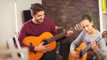 Music Teacher Teaching Student Guitar