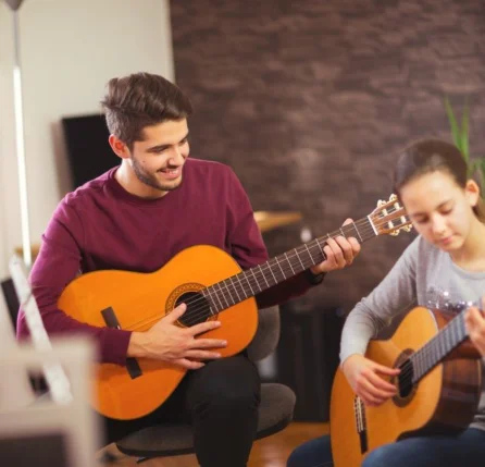 Music Teacher Teaching Student Guitar